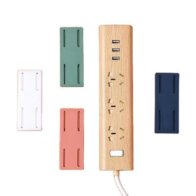 China Viable Wall Mounted Seamless Free Stand Holder Punch Fixer Self Adhesive Receptacle Socket Fixer for sale