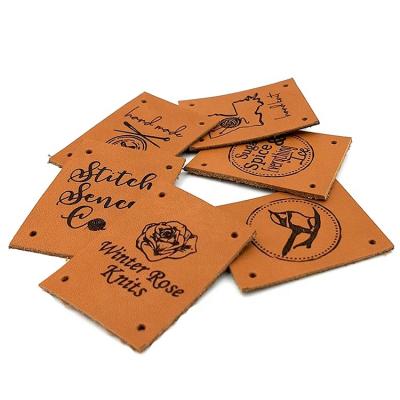 China Handmade Wholesale Cut Hole Sew On Leather Label Printing Logo Leather Patches for sale