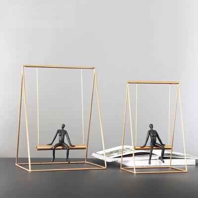 China Simple Nordic Europe Design Character Sculpture Abstract Black Resin Open Swing Frame Metal Gold Crafts For Home Decoration for sale