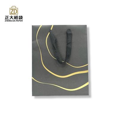 China Eco - Friendly Premium Black Card Paper Bag Cosmetics Shopping Bag for sale