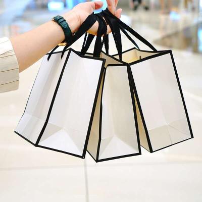 China Recyclable Custom Company Logo Printing Small Cheap White Paper Gift Bags With Handle For Christmas for sale