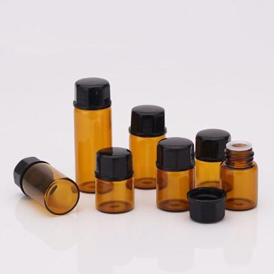 China Wholesale Cosmetic Brown Mini Glass Bottles With Screw Essential Oil Glass Bottle Round Clear Lid for sale