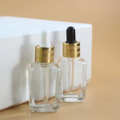 China 15ml square cosmetic clear shape glass dropper bottle with gold screw dropper cap for sale