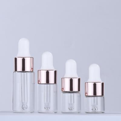 China samll cosmetic custom round logo amber transparent oil 1ml 2ml 3ml 5ml rose gold dropper bottle for sale