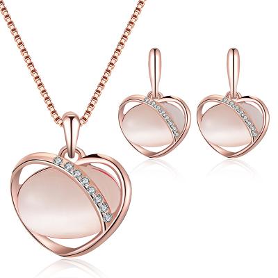 China New Romantic Gold Rhinestone Alloy Love Necklace Earrings Set Oval Cat Eye Jewelry Set Peach Heart Jewelry Set for sale