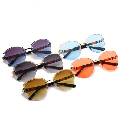 China Hot Selling Rimless Fashion Cut-Edge Sunglasses Women Shape Temple Sun Glasses Multicolor Cat Eye Sunglasses Wholesale for sale