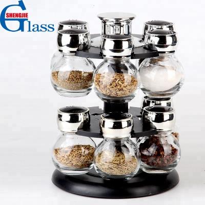 China Sustainable Decorative Revolving Glass Spice Jar Rack Set With Plastic Holder for sale