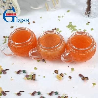 China Traditional Football Shaped Creative Glass Cup Beer Mug Coffee Water Glass Cup With Handle for sale