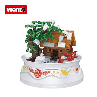 China Building Toy WOMA TOYS Walmart 2022 Hottest Sale Christmas Ice Snow Room House Rotate Playback Music Box Small Brick Building Blocks Set for sale