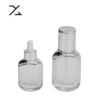 China Thick Bottom Transparent Empty Glass Cosmetic Bottle 30ml Square Lotion Bottle With Pump Glass Bottles for sale