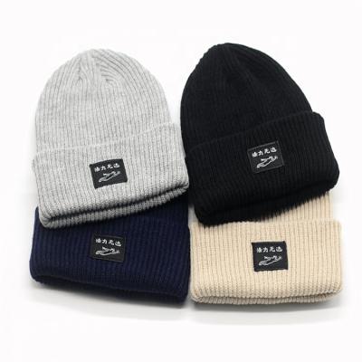 China Cheap Custom Factory COMMON Plain Solid Color Logo Unisex Winter Knit Beanie Cap With Woven Label for sale