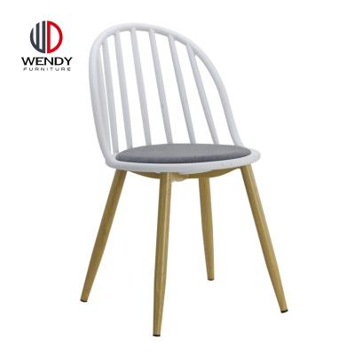 China Contemporary Modern Colorful Plastic Chairs With Metal Legs Fabric Cushion for sale