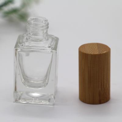 China Personal Care 15ml Square Bamboo Cap Glass Empty Nail Polish Bottle for sale