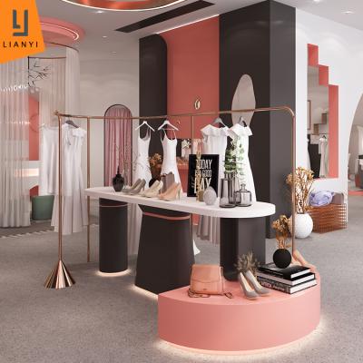 China Fashionable Rose Gold Clothing Display Rack MDF Wedding Dress Shoes Display Stand For Garment Store for sale