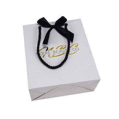 China Recycled Materials Custom Logo White Paper Gift Bag With Black Bow for sale