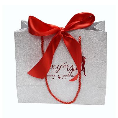 China Recycled Materials Glitter Gift Paper Bags With Logo And Red Ribbon for sale