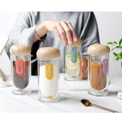 China Beverage Instagram Followers Fashion Simple Double Wall Portable Water Bottle Glass With Wooden Cap for sale