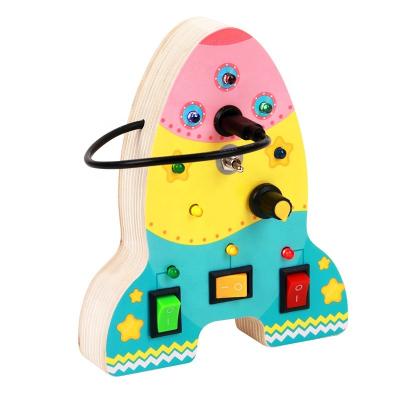 China Busy Toy Play Montessori Rocket Shape Board For Toddlers Wooden Sensory Toys For Toddlers With Turning On LED Button Baby Gifts for sale