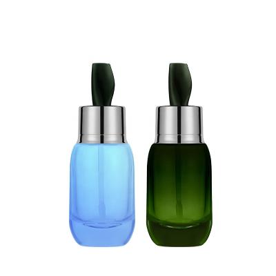 China Cosmetic Unique 50ml Glass Round Cosmetic Dropper Bottle With Dropper For Skin Care for sale