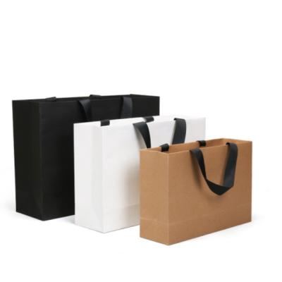 China Recyclable Wholesale Shoes Clothes Kraft Paper Bags Printed Custom Logo Shopping Gift Packaging Paper Bag for sale