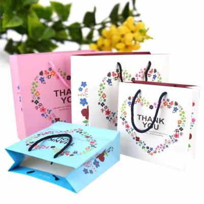 China Materials Manufacturer Recycled Biodegradable Printed Logo Paper Gift Bag For Clothing Packaging Wedding Cosmetic Paper Bags With Ribbon For Jewelry for sale