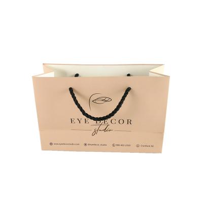 China Custom Printed Logo Handmade Garment Garment Paper Packaging Bag for sale