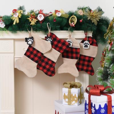 China Festival Stuff Christmas Hot Seller Items For Christmas Dog Stocking Plaid Paw Print Pet Sublimation Stocking Plaid Candy Gift Canvas Bag 2022 for sale