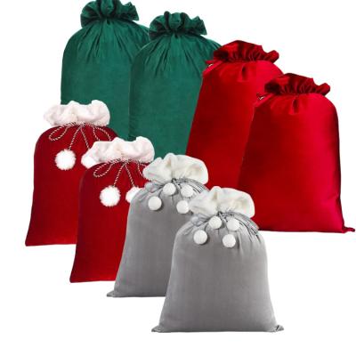 China Festival Stuff 2022 Christmas Pom Pom Santa Sack Luxury Red Large Plush Velvet Drawstring Gift Bag Custom High Quality Sublimation Empty Bag for sale