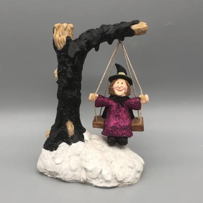 China Western Halloween Table Witch Polyresin Tree Designed Swing And Witch Sculpture for sale