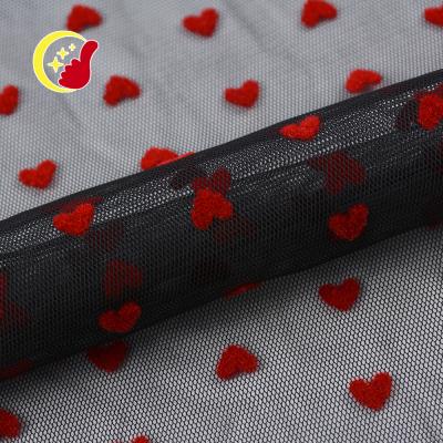 China Factory price heart design 100 poly materials anti-static knitting elastic flocking net mesh fabric for wedding for sale