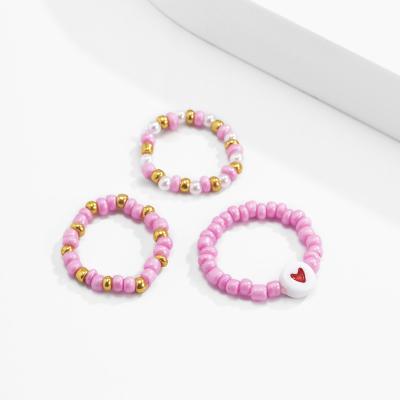 China Sweet Pink Acrylic Bead Ring Female Woven Heart Design Vintage Heart Pattern Rice Knuckle Ring Set for sale