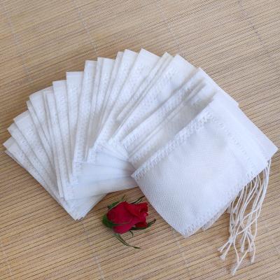 China Disposable 100 Pieces Flower Powder Tea Natural Drawstring Filter Bags Empty Non Woven Drawstring Bags for sale