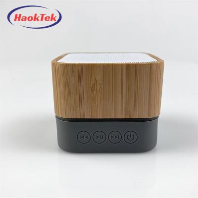 China LED Flashing Light HAOKTEK Wooden Bamboo Square Mini Portable Radio Led Light Mini Speaker For Mobile Phone for sale