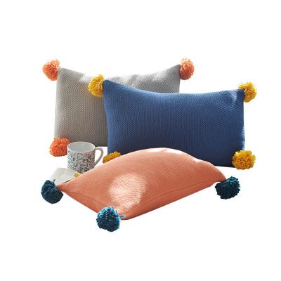 China Non-toxic hot sale orange oblong soft lightweight cotton knitted cover cushions for sofa with tassels for sale