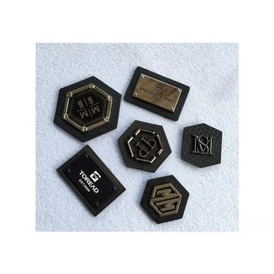 China Various Shapes Durable Custom PU Leather Labels For Silver Metal Labels For Clothing Bags for sale