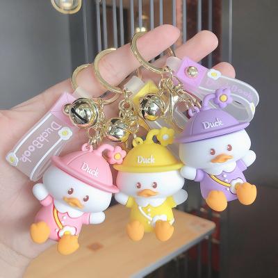 China Soft Cute Silicone Cartoon Duck Key Chain Toy Compression Bag Cute Car Doll Small Sitting Key Chain Pendant Gift for sale