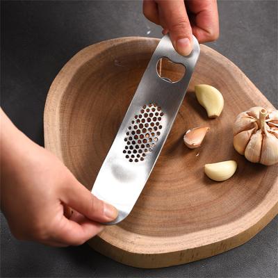 China Viable Kitchen Instruments Cooking Tools 2 in 1 Stainless Steel Garlic Press Ginger Rocker Crusher Squeezer Mini with Bottle Opener for sale