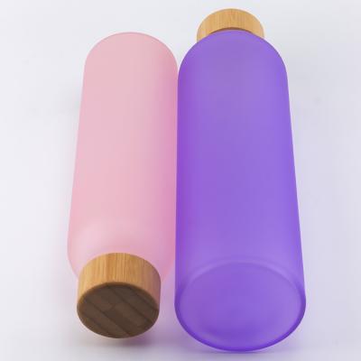 China Quality Guaranteed Custom Logo Bamboo Lids Pink Personalized Glass Water Bottle Viable With Silicone Sleeve for sale