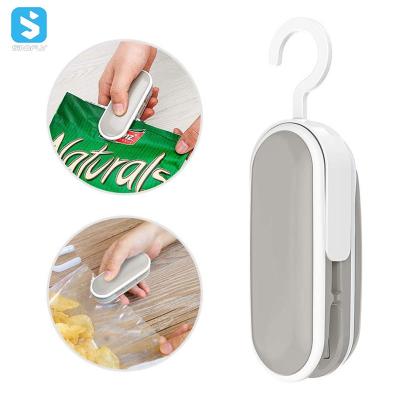 China Mini Portable 2in1 Food Plastic Bag Cutter Vacuum Sealer Heat Bag Food Vacuum Sealer Using Bags Rolls Sealing for sale