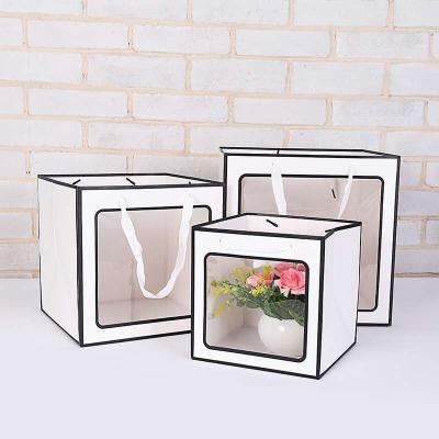 China Recyclable Portable Rope Transparent Window Paper Bag Square Shape PVC Gift Flower Clear Paper Bag for sale