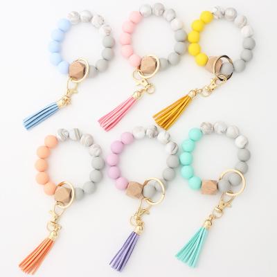 China Newest Modern Beaded Bracelet Summer Silicone Rubber Band with Wooden Beads Suede Key Chain Personalized Wooden Beads for sale