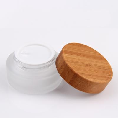 China Cosmetic Luxury Round Cosmetic Container Clear Frosted Bamboo Cosmetic Jars 30ml 50ml 100ml Glass Bottles With Lid for sale