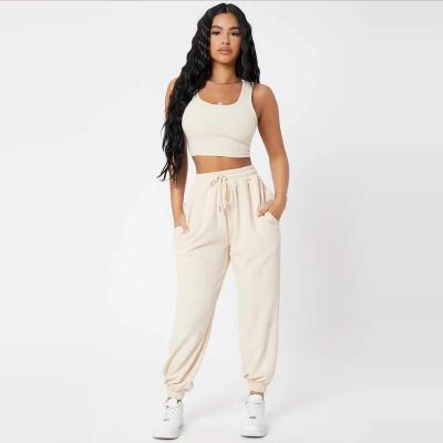 China 2021 Hot Selling QUICK DRY Women Crop Sleeveless Top And Jogger Set Solid Color Polyester Two Piece Panty Set With Drawstring for sale