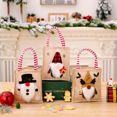 China Christmas Party Christmas Decoration Cartoon Printing Burlap Gift Sack Festival Decor Kids Xmas Tote Bag for sale