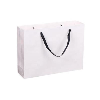 China Recyclable Custom Coated Paper Made White Cardboard Paper Tote Clothing Bag With Logo Print For Garment Store for sale