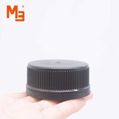 China Wonderful hand feeling. 50mm Smooth Feeling Unscrew Poly Seal Black Ribbed Cone Coating Plastic Phenolic Caps For Glass Bottles for sale