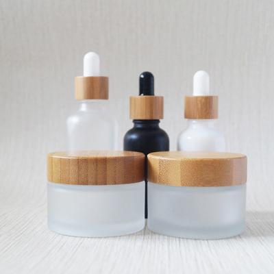 China New Design 30ml 50ml 100ml Cosmetic Wholesale Cosmetic Frosted Glass Jar With Bamboo Lids for sale