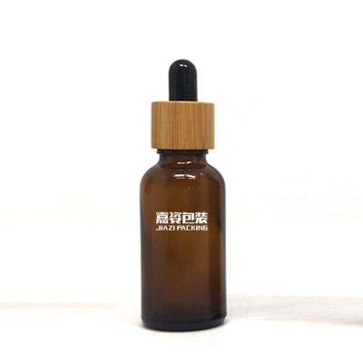 China 15ml 20ml 30ml 50ml 100ml cosmetic custom printed amber serum oil round glass bottles with dropper with bamboo lid for sale