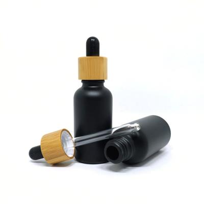 China Essential Oil 30ml Matte Black Glass Bamboo Dropper Bottle Cap Essential Oil Cosmetic Packaging Bamboo Bottle for sale