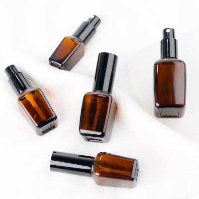 China Eco - Friendly Recyclable Glass Lotion Pump Bottle Spray Amber Square Essential Oil Bottles for sale